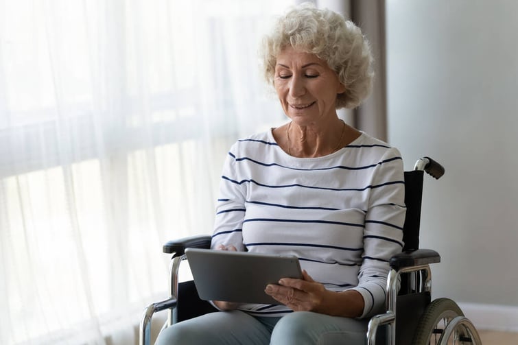 rsz_patient-female-holding-tablet-in-wheelchair--shutterstock-1562123086